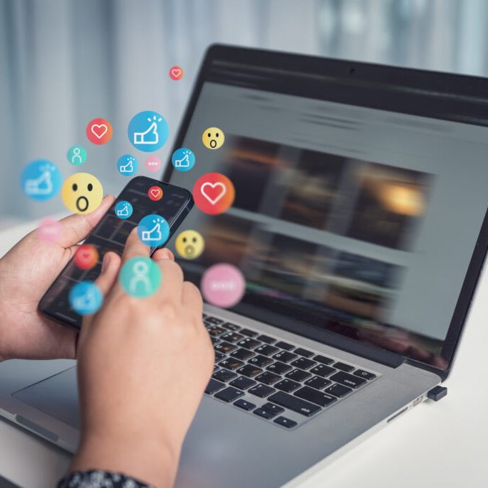 AmberAssists. Virtual Assistant. Laptop with Social Medio open with phone with notification bubbles around it